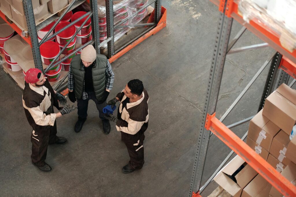 Men Standing in a Warehouse Talking