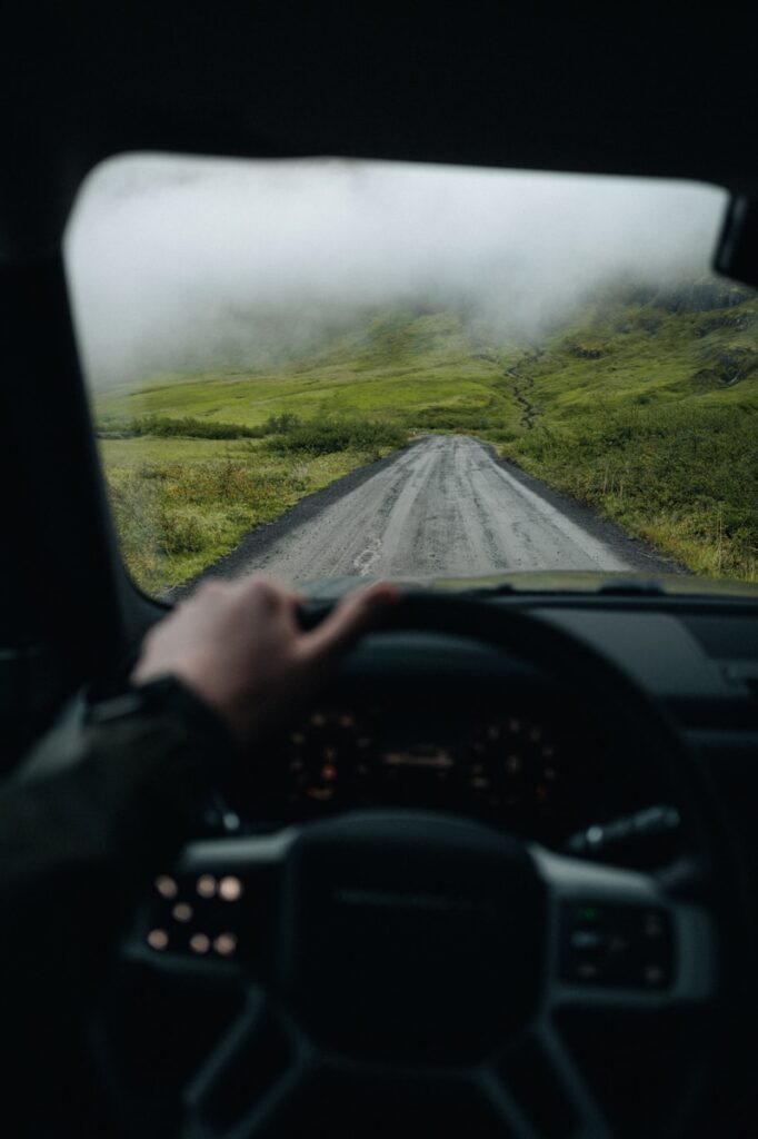 A person driving a car down a rural road