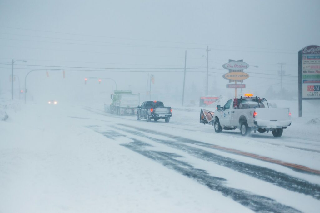vehicles passing on road covered with snow
