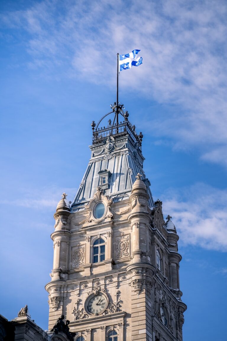 a clock tower with a flag on top of it