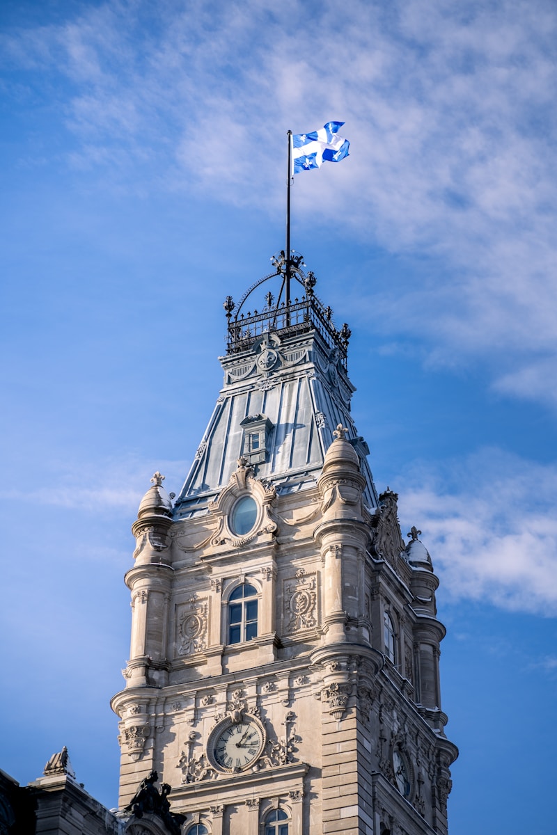 a clock tower with a flag on top of it