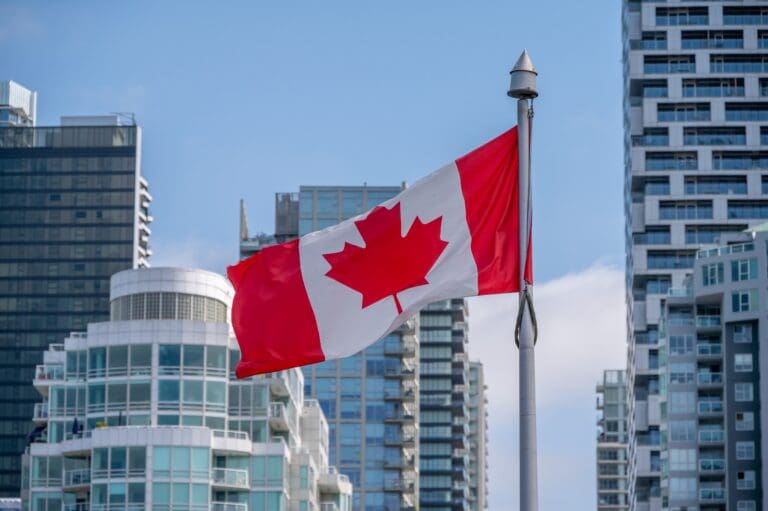 Canadian,Flag,With,Downtown,Vancouver,In,Background