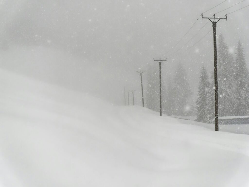 a person riding skis down a snow covered slope