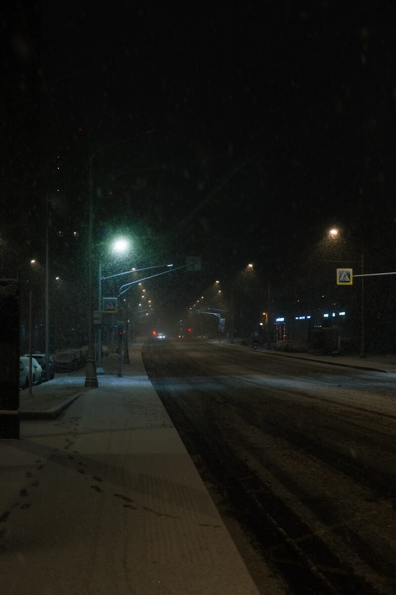 Snowfall on a city street at night